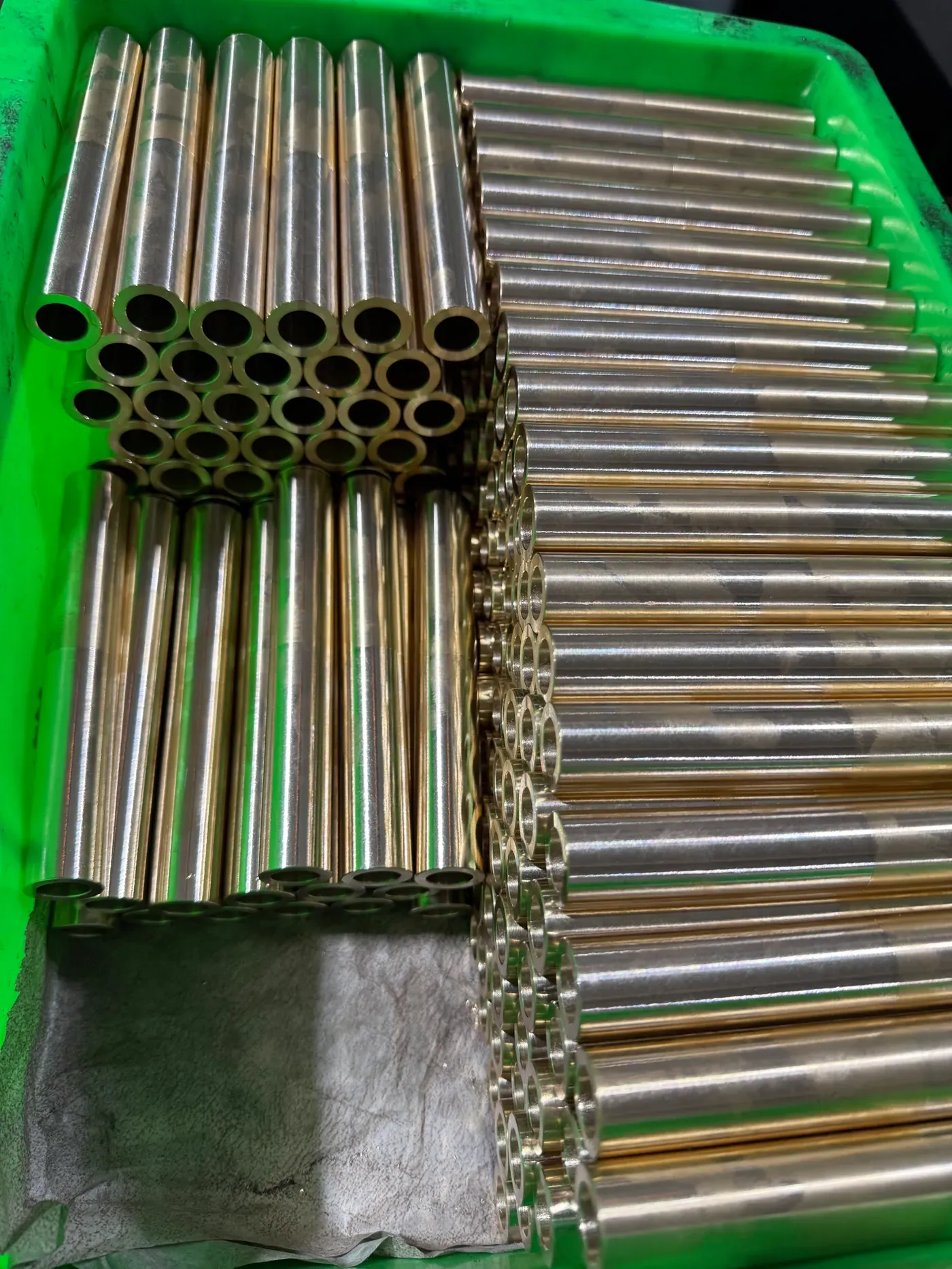 Cast bronze bar and tube stock on a rack in the machine shop