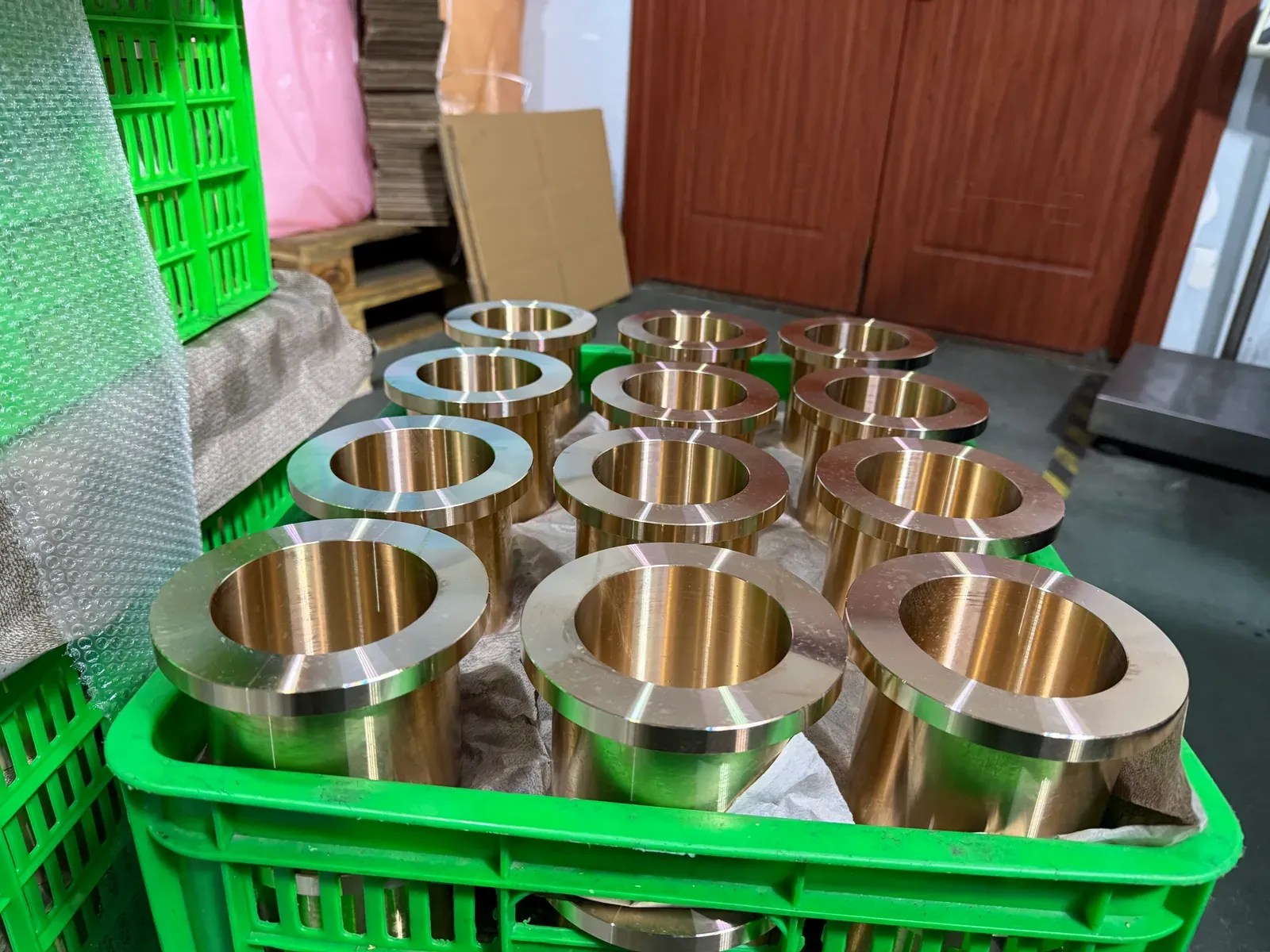 Flanged cast bronze bushings in a basket, flange faces up